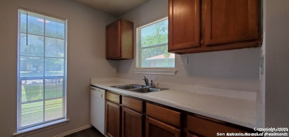 5236 Meadow Rise Street San Antonio, TX 78250 - Photo 10 of 25 a kitchen with a sink a window and cabinets