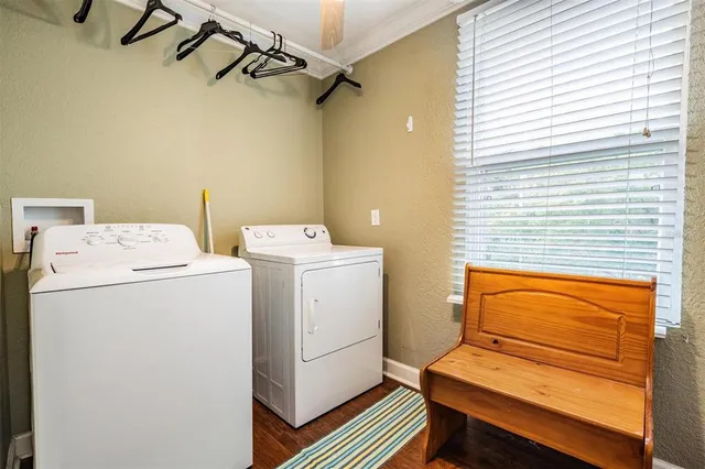 a large white kitchen with lots of counter space and breakfast area
