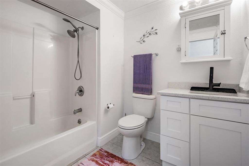 815 2nd Avenue Northwest Ruskin, FL 33570 - Photo 47 of 86 a bathroom with a bathtub shower sink vanity and toilet