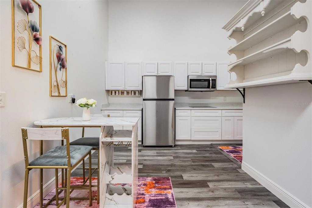 815 2nd Avenue Northwest Ruskin, FL 33570 - Photo 48 of 86 a kitchen with stainless steel appliances wooden floor and a refrigerator