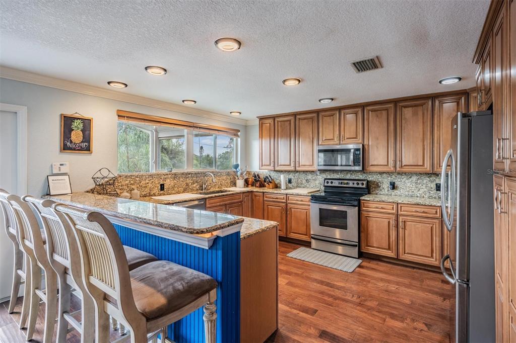815 2nd Avenue Northwest Ruskin, FL 33570 - Photo 10 of 86 a kitchen with stainless steel appliances granite countertop sink stove top oven and cabinets