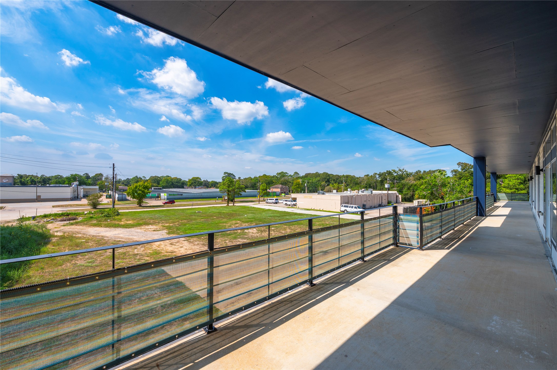 119 Kirby Road, Unit 5205 Seabrook, TX 77586 - Photo 46 of 46 Expansive balcony offers a serene view of open green spaces and distant trees, perfect for relaxing and enjoying the outdoors.