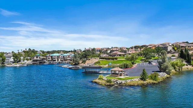 a view of a lake with boats and trees in the background