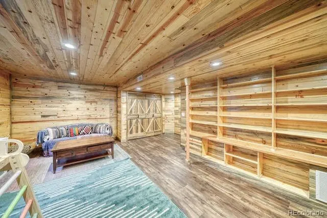 a view of a patio with table and chairs with wooden floor and fence