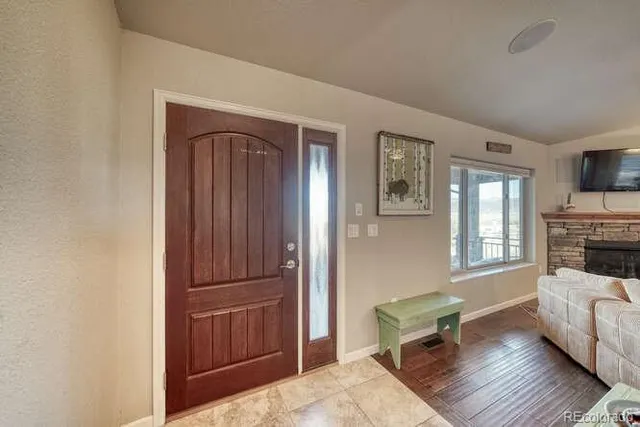 a living room with fireplace furniture and a flat screen tv