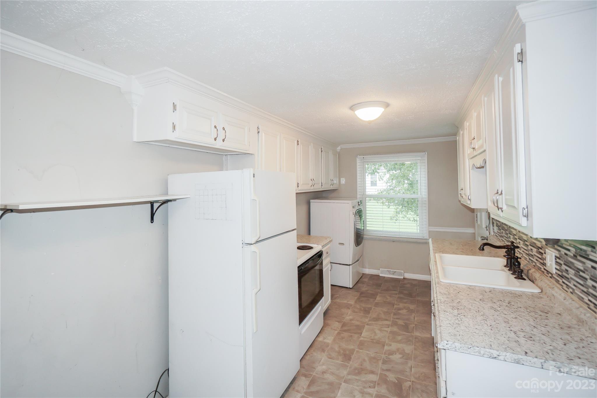 720 Flint Street Rock Hill, SC 29730 - Photo 11 of 20 a view of a kitchen with a sink and refrigerator