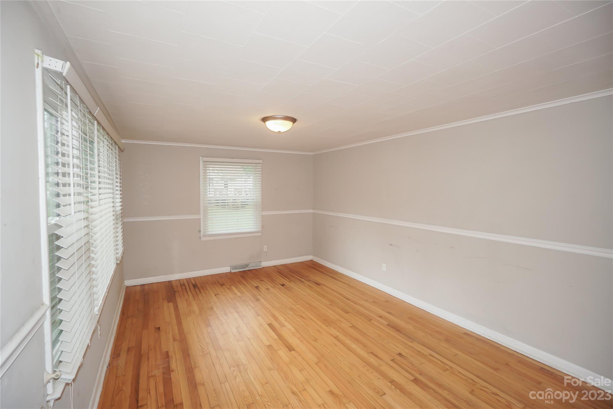 720 Flint Street Rock Hill, SC 29730 - Photo 4 of 20 a view of an empty room with wooden floor and a window