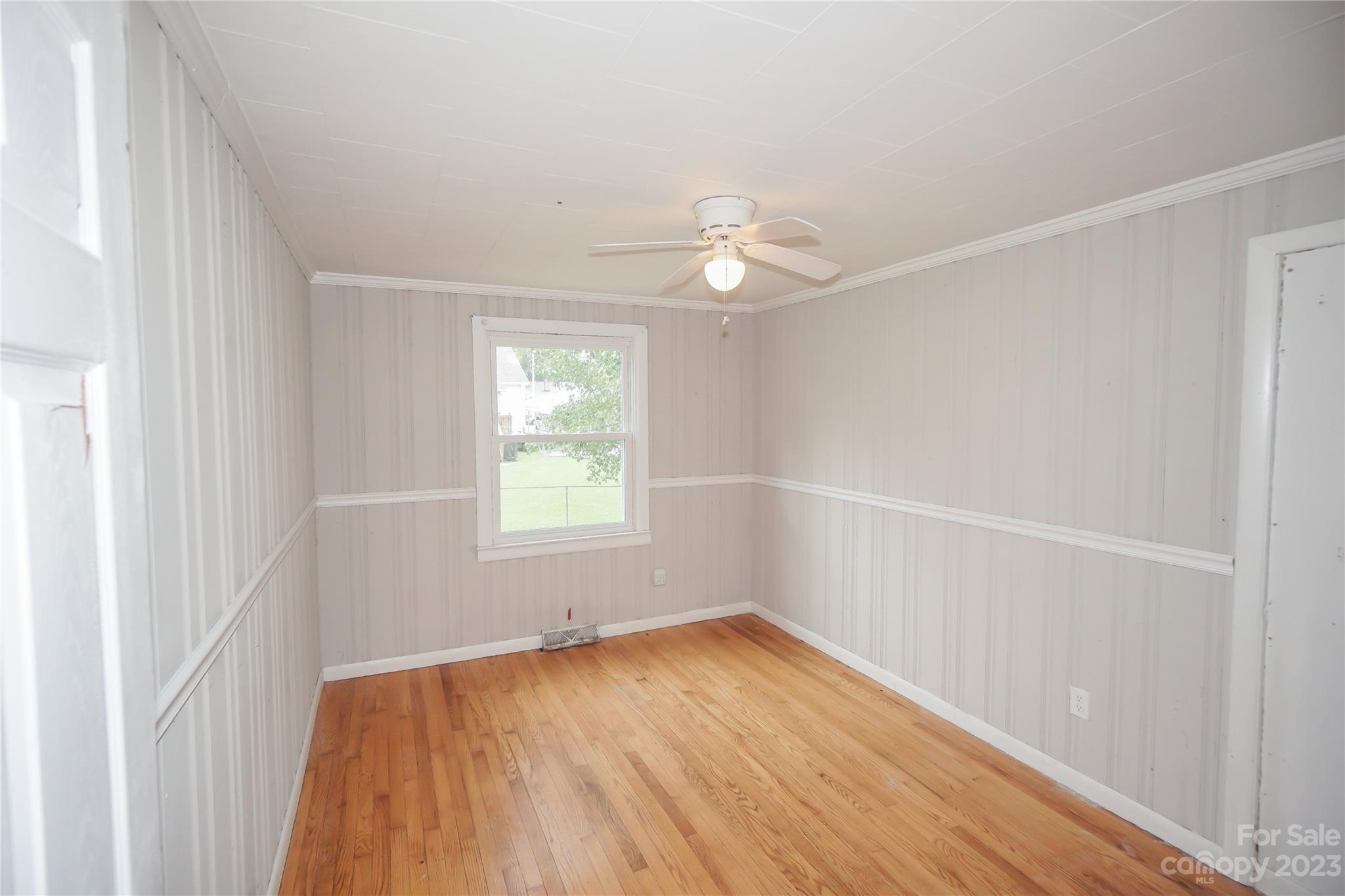720 Flint Street Rock Hill, SC 29730 - Photo 6 of 20 an empty room with a window and wooden floor