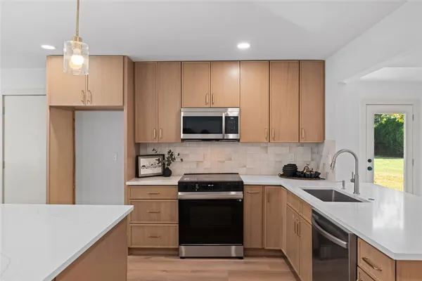 a kitchen with a sink a stove and refrigerator