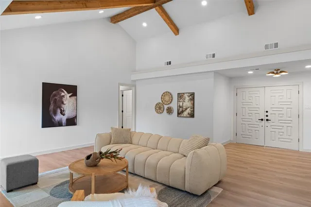 a living room with furniture and a wall painting