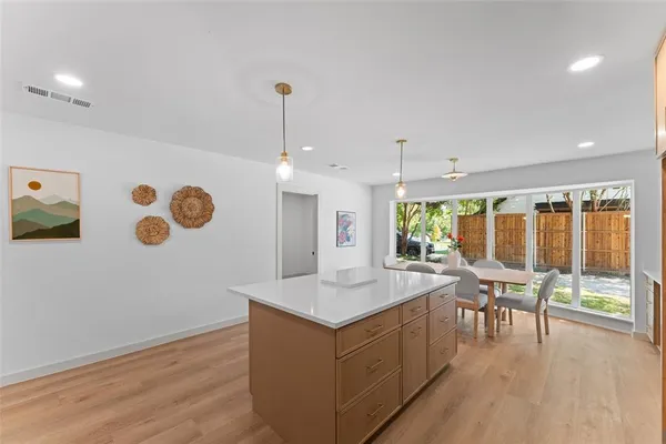 a large white kitchen with a large window