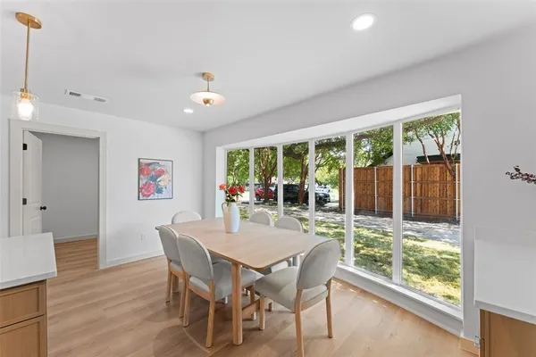 a dining room with furniture window outside view and wooden floor
