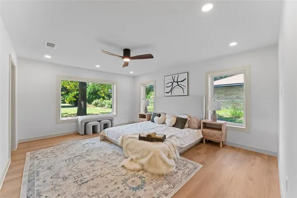 a bed room with a bed and a large window