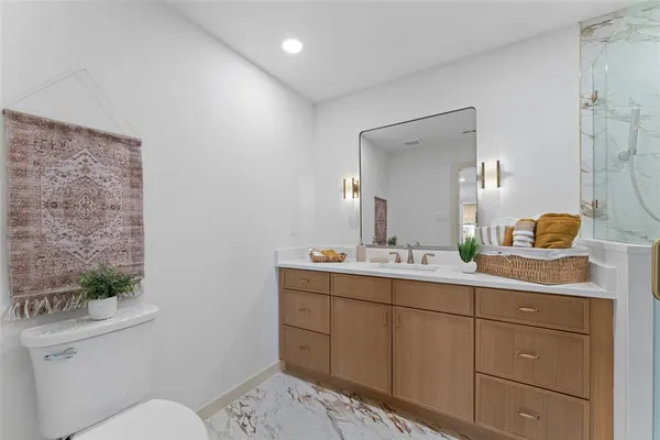 a bathroom with a toilet sink and mirror