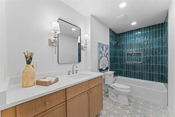 a bathroom with a double vanity sink toilet and shower