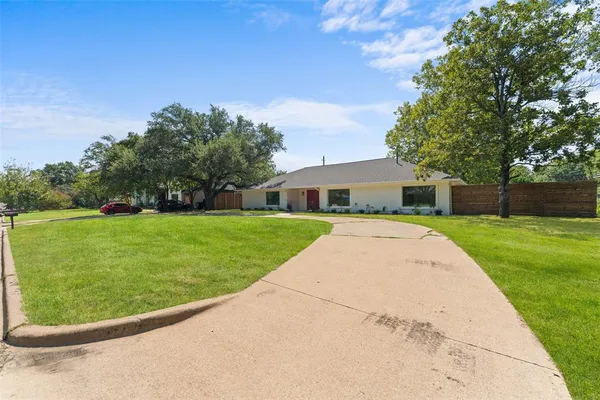 a view of house with backyard