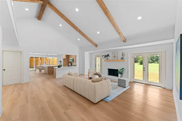 a living room with fireplace furniture and a wooden floor