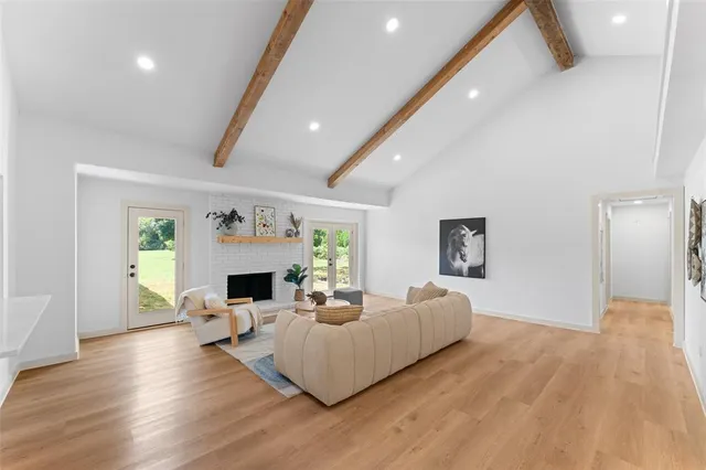 a living room with fireplace furniture and a wooden floor