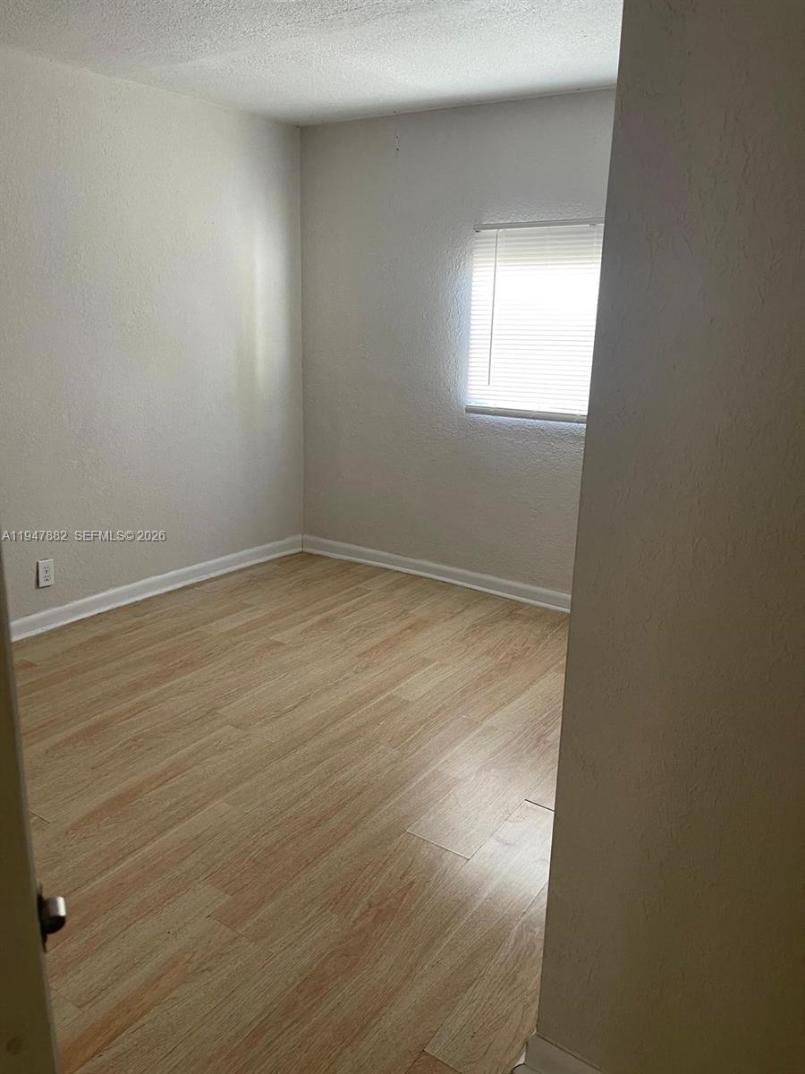 13110 Southwest 10th Street Miami, FL 33184 - Photo 11 of 12 an empty room with a window