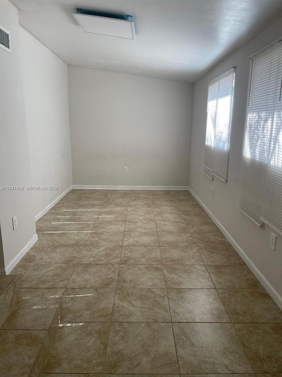 13110 Southwest 10th Street Miami, FL 33184 - Photo 12 of 12 a view of an empty room and window