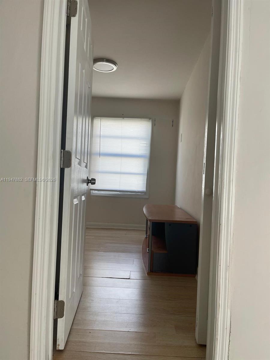 13110 Southwest 10th Street Miami, FL 33184 - Photo 8 of 12 a view of entryway and hall with wooden floor