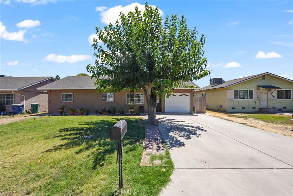 a front view of house with yard and trees