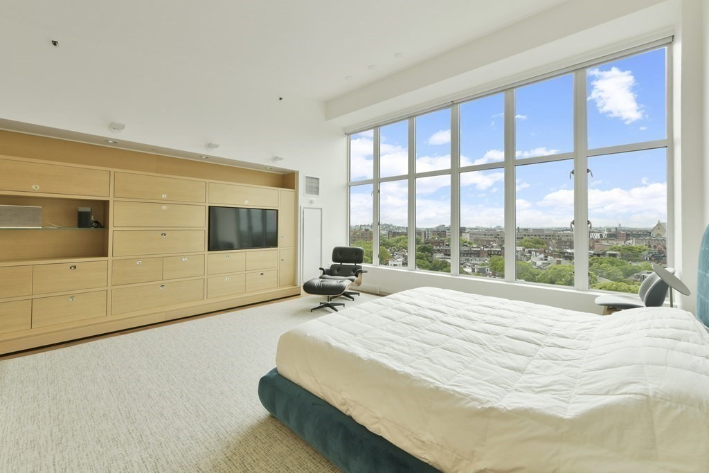 505 Tremont Street, Unit 904 Boston, MA 02116 - Photo 12 of 16 a bed sitting in a spacious bedroom next to a window