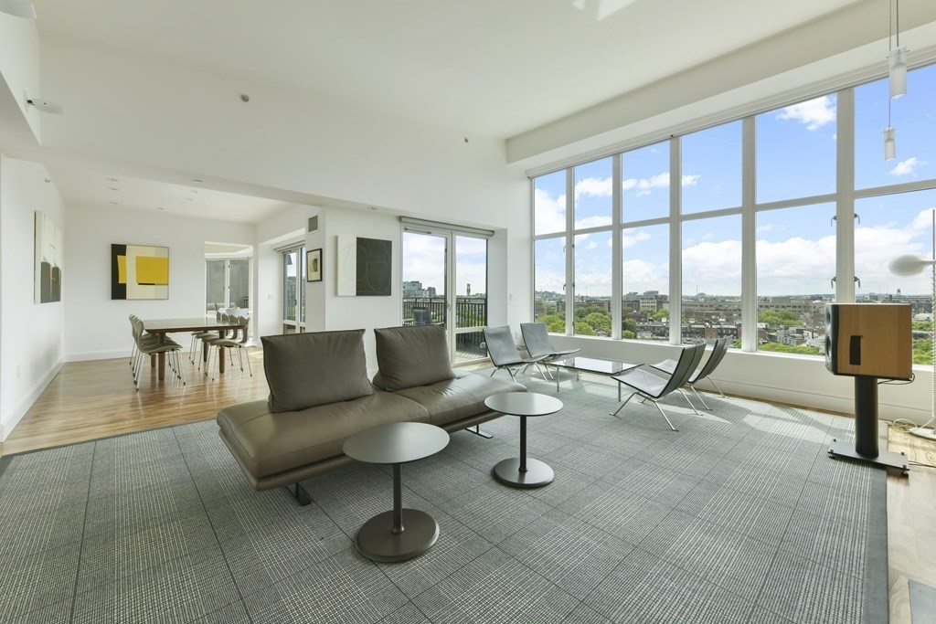 505 Tremont Street, Unit 904 Boston, MA 02116 - Photo 2 of 16 a living room with furniture and a floor to ceiling window