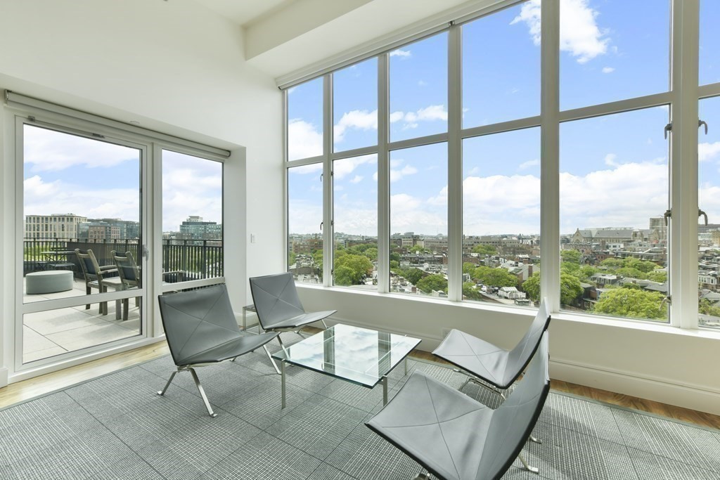 505 Tremont Street, Unit 904 Boston, MA 02116 - Photo 3 of 16 a living room with furniture and floor to ceiling windows