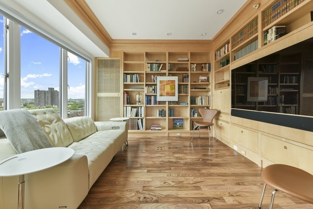 505 Tremont Street, Unit 904 Boston, MA 02116 - Photo 7 of 16 a living room with furniture and a flat screen tv