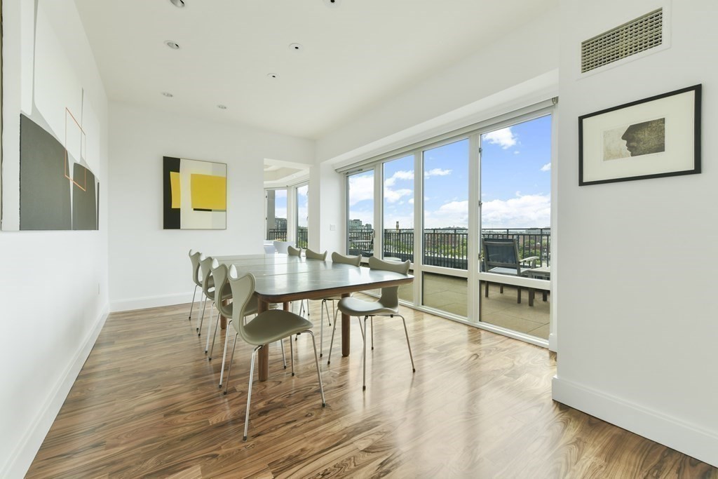 505 Tremont Street, Unit 904 Boston, MA 02116 - Photo 9 of 16 a dining room with furniture and wooden floor