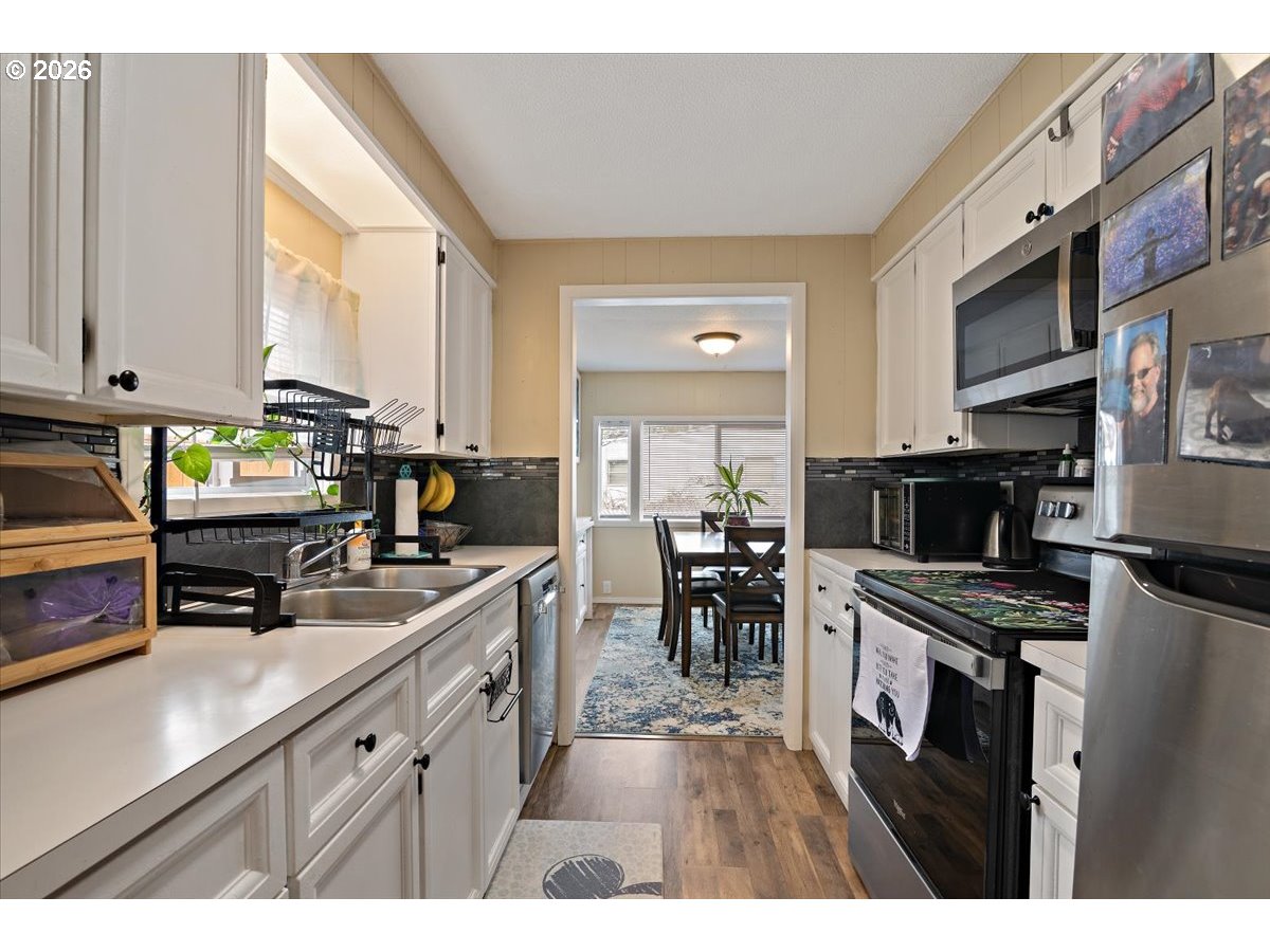 5355 River Road North, Unit 60 Keizer, OR 97303 - Photo 15 of 29 a kitchen with stainless steel appliances a stove top oven a sink a counter space and cabinets