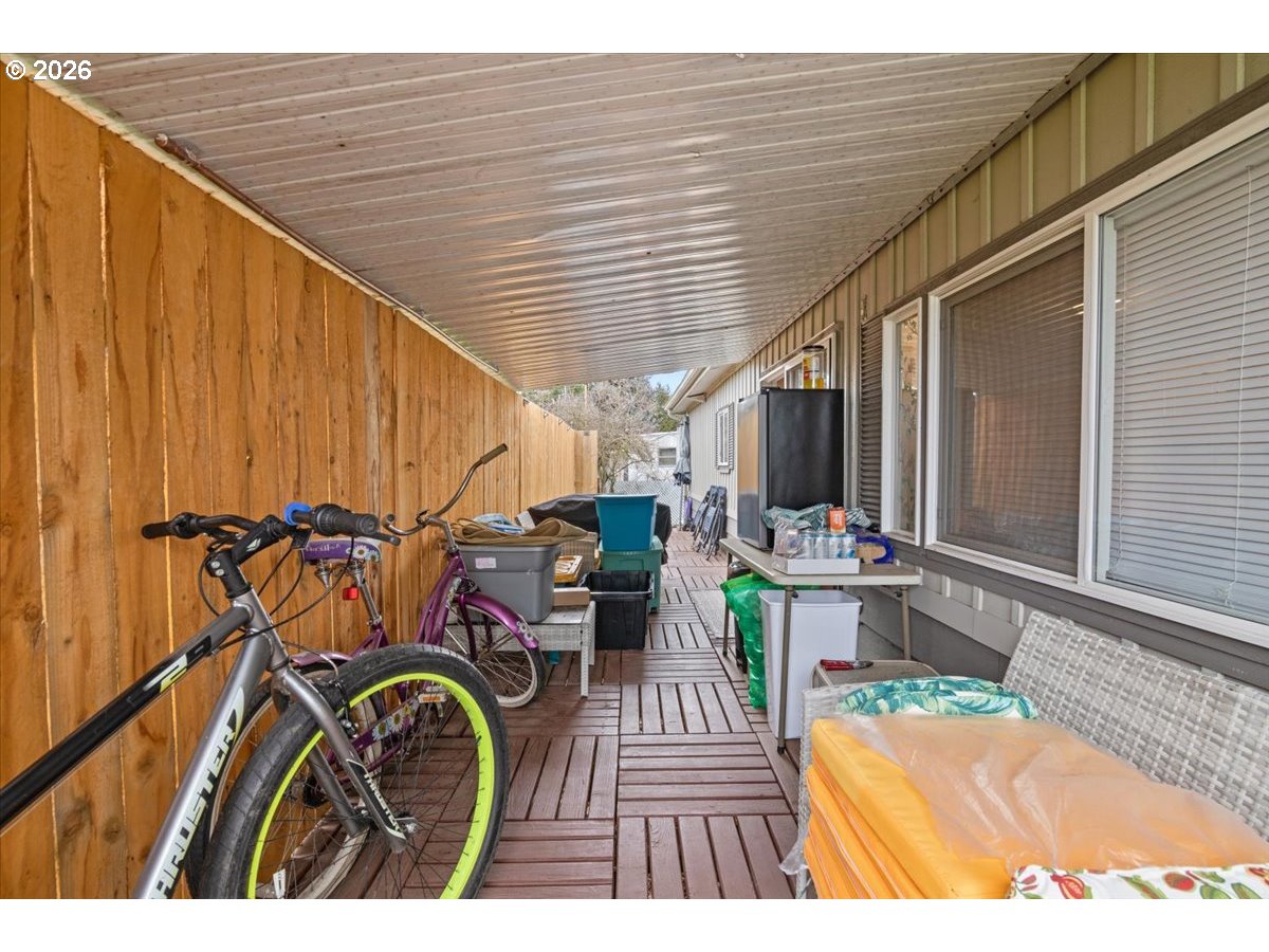 5355 River Road North, Unit 60 Keizer, OR 97303 - Photo 26 of 29 a view of a patio with table and chairs with wooden fence and plants
