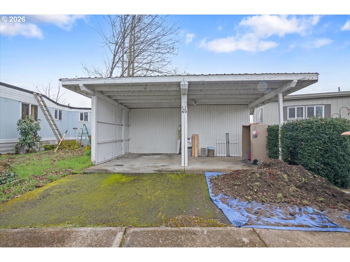 5355 River Road North, Unit 60 Keizer, OR 97303 - Photo 28 of 29 a view of a house with a yard and garage