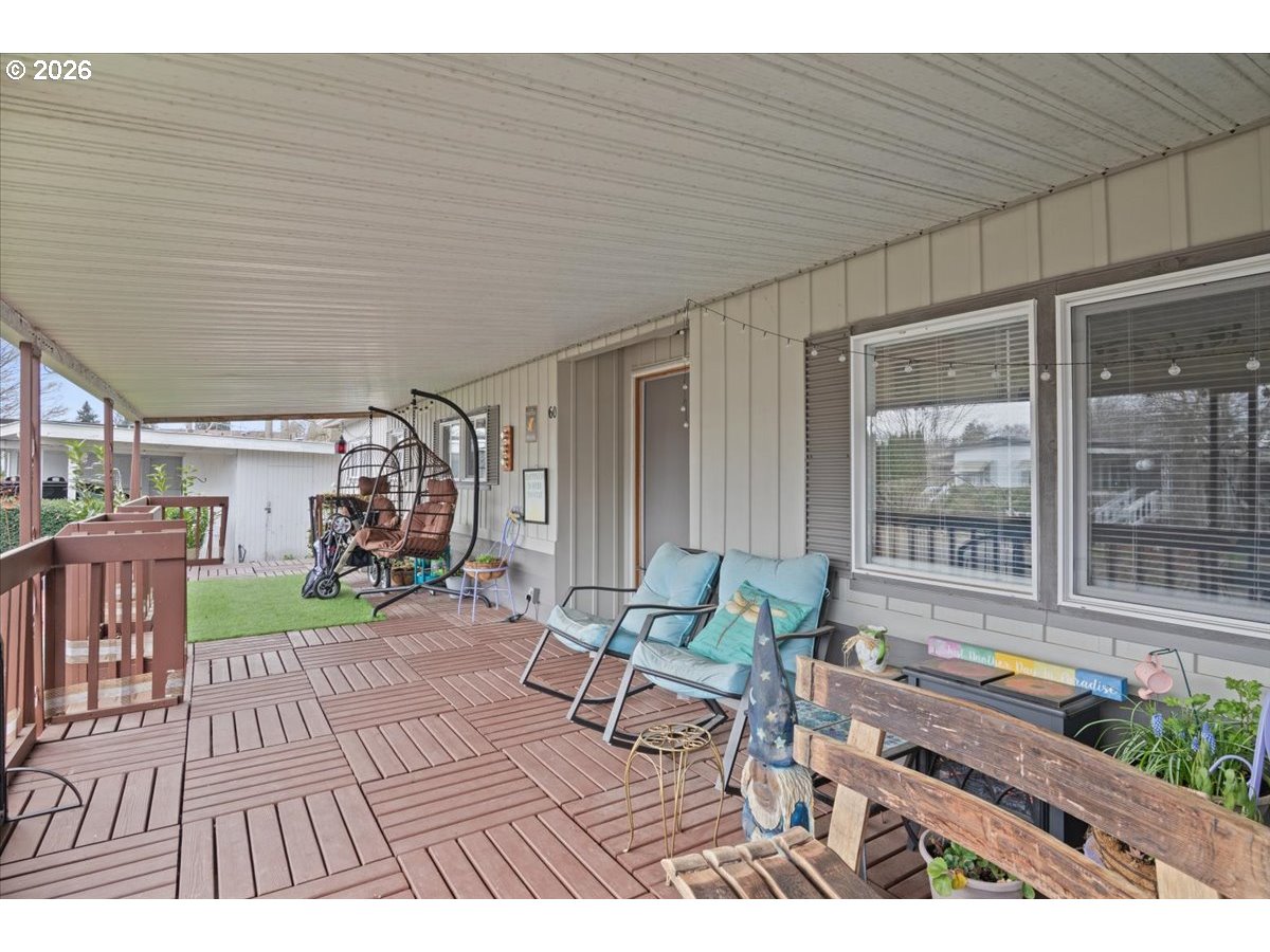 5355 River Road North, Unit 60 Keizer, OR 97303 - Photo 3 of 29 a view of a patio with table and chairs potted plants with wooden floor