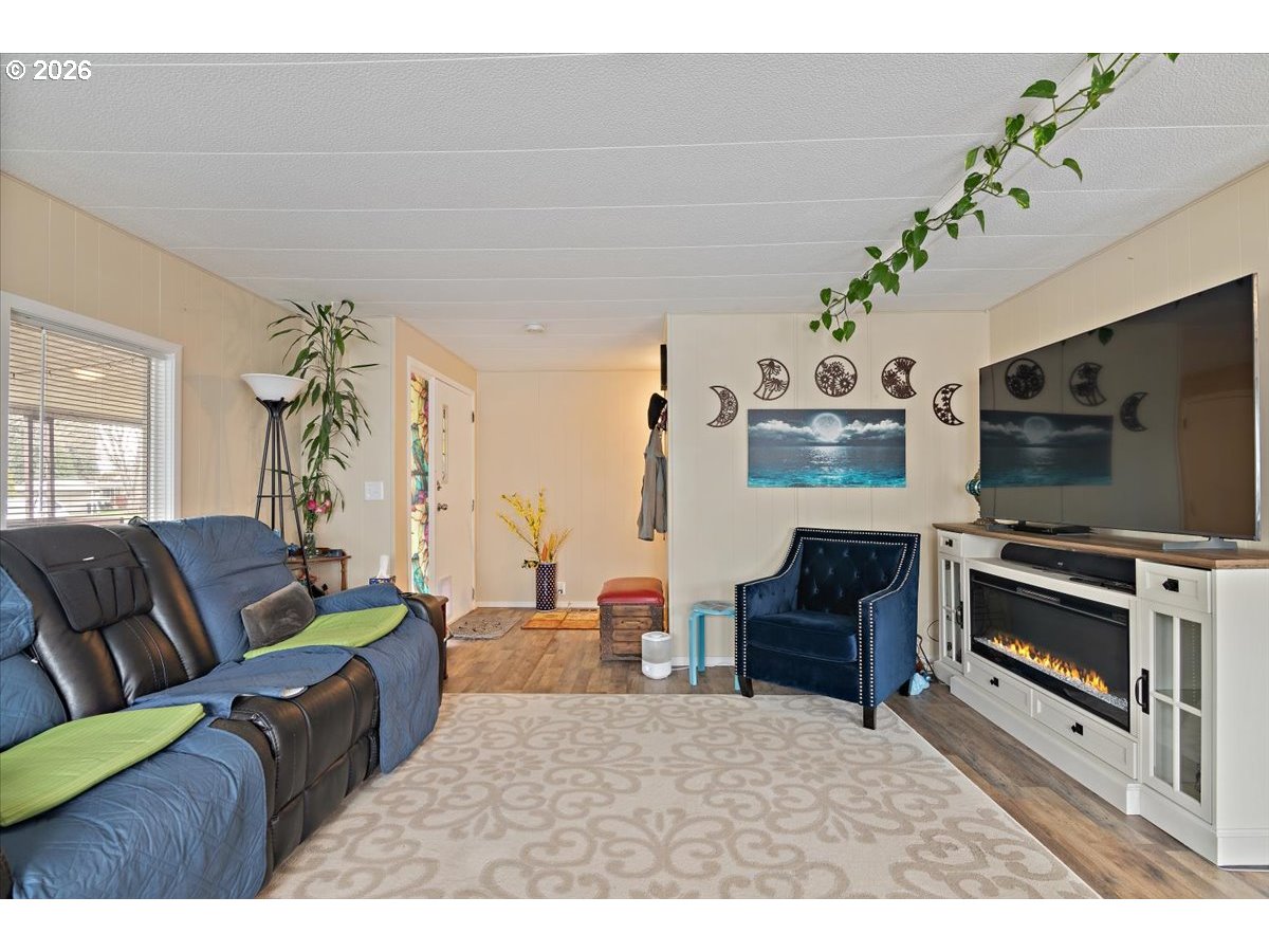 5355 River Road North, Unit 60 Keizer, OR 97303 - Photo 7 of 29 a living room with furniture and a flat screen tv