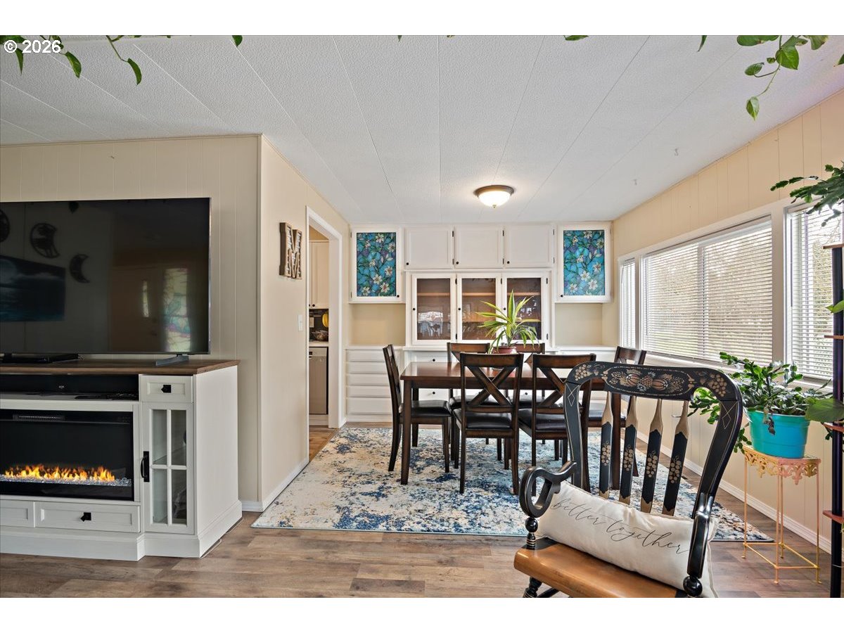 5355 River Road North, Unit 60 Keizer, OR 97303 - Photo 8 of 29 a view of a dining room with furniture window and wooden floor