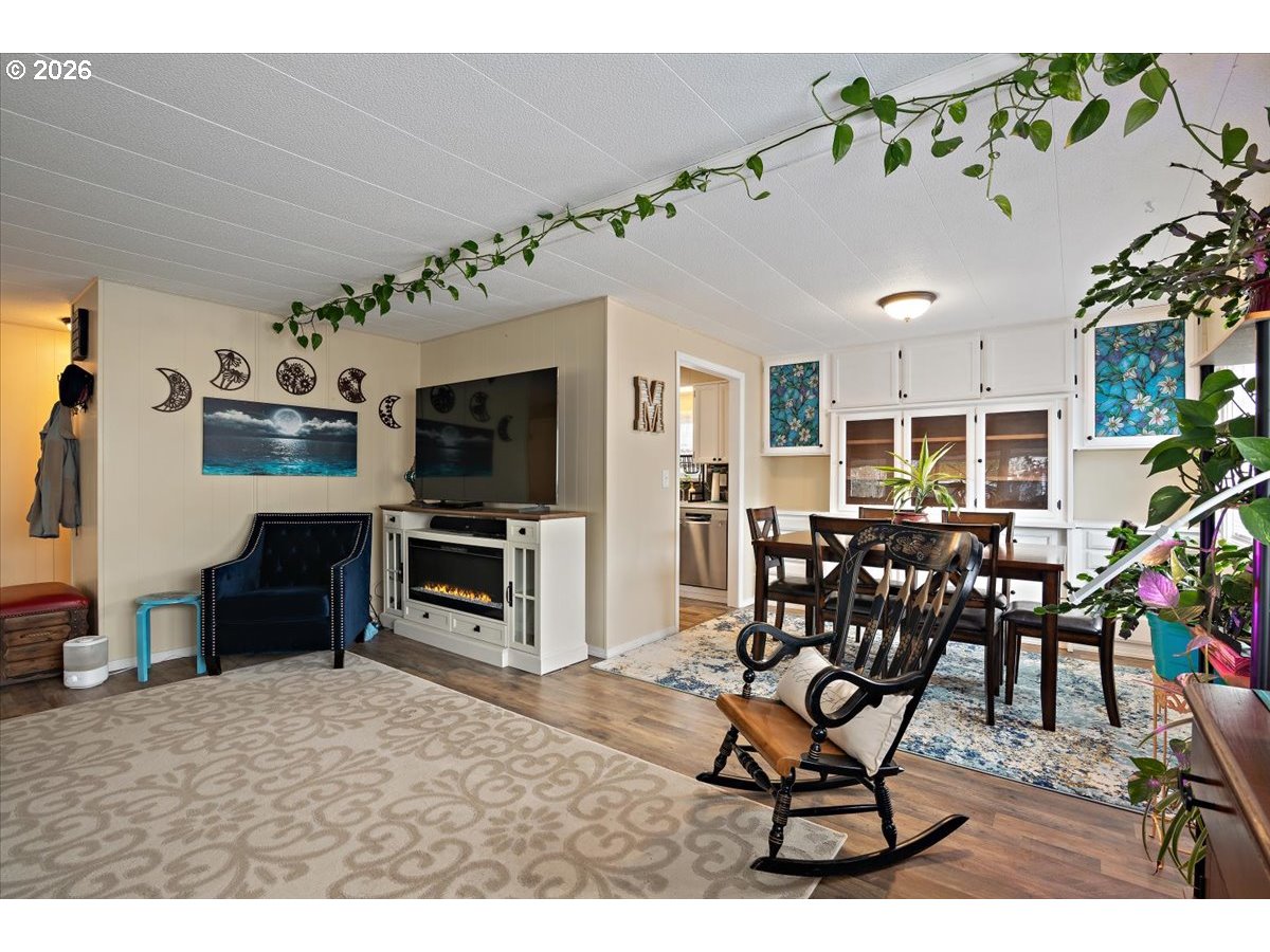 5355 River Road North, Unit 60 Keizer, OR 97303 - Photo 9 of 29 a living room with furniture a flat screen tv and kitchen view
