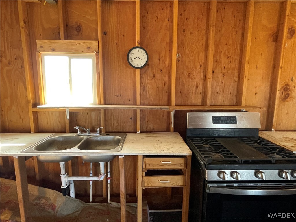 14360 Aripine Road Yucca, AZ 86438 - Photo 15 of 33 a kitchen with a stove and a table
