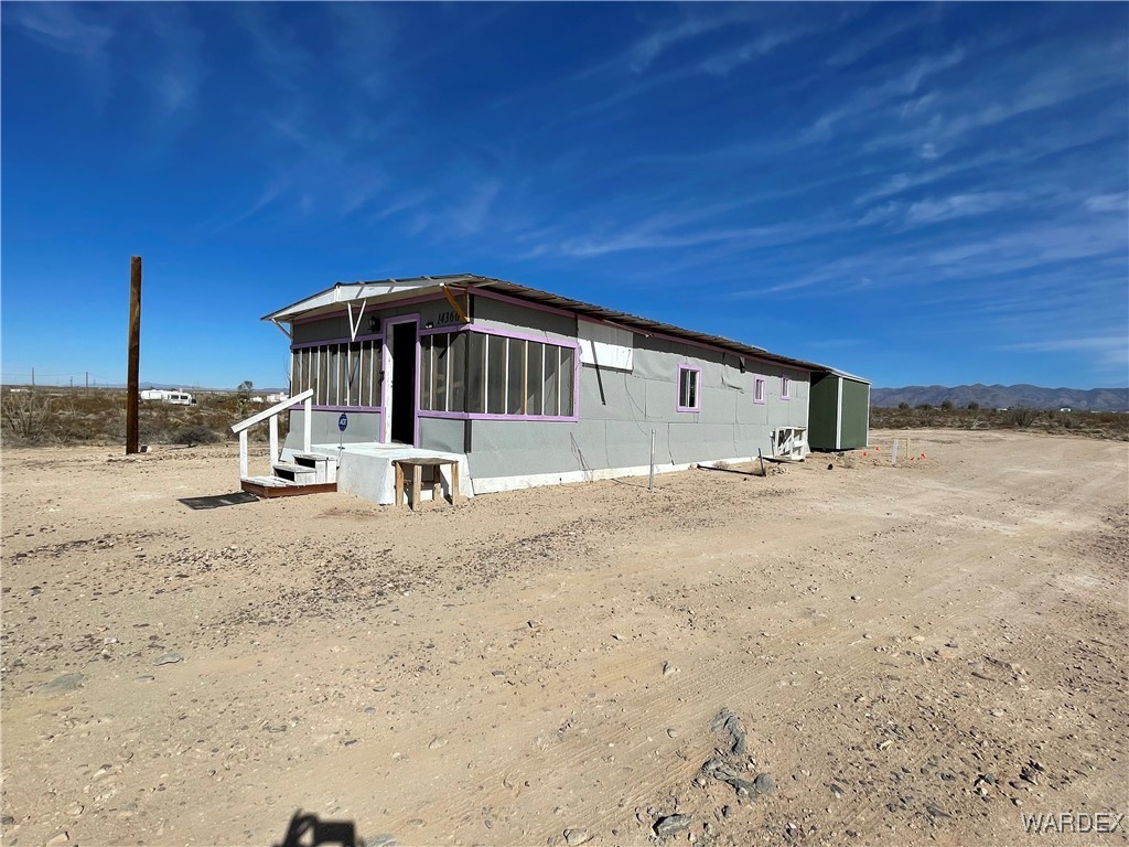 14360 Aripine Road Yucca, AZ 86438 - Photo 2 of 33 a view of a back yard of the house
