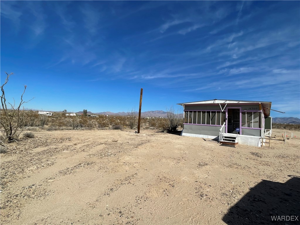 14360 Aripine Road Yucca, AZ 86438 - Photo 24 of 33 a wooden bench sitting in the middle of a yard