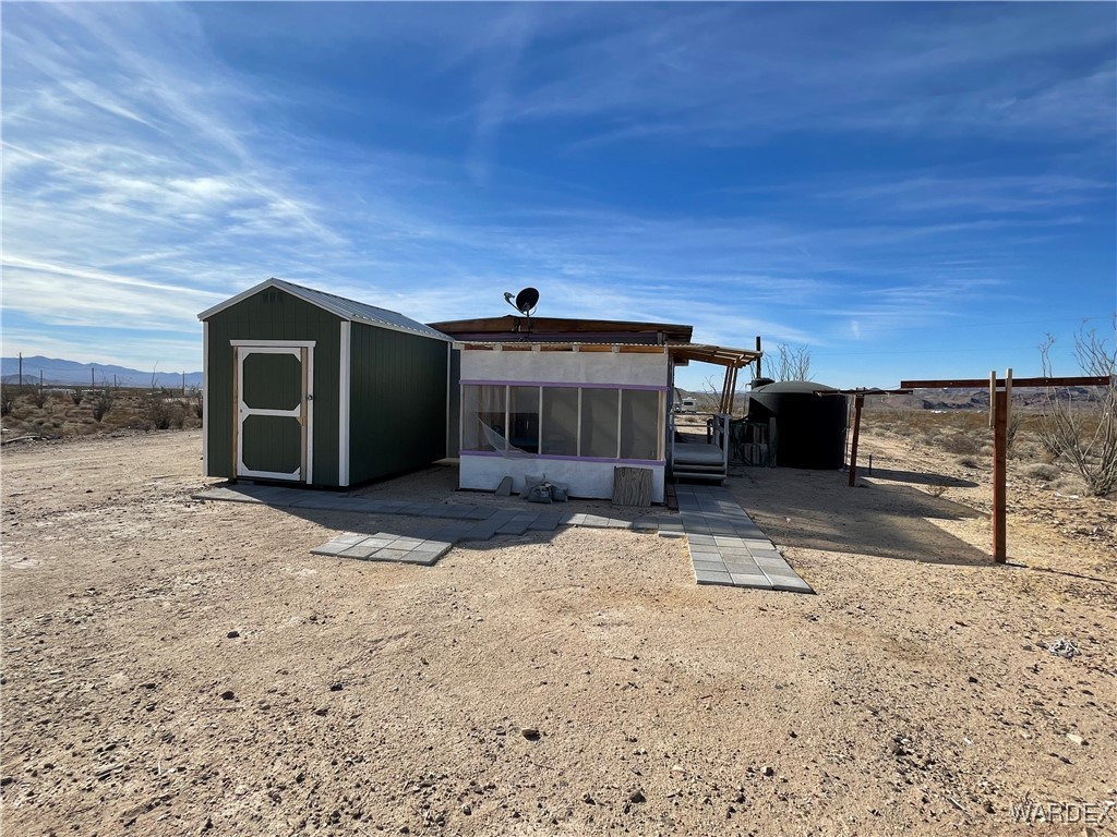 14360 Aripine Road Yucca, AZ 86438 - Photo 28 of 33 a front view of a house with a yard