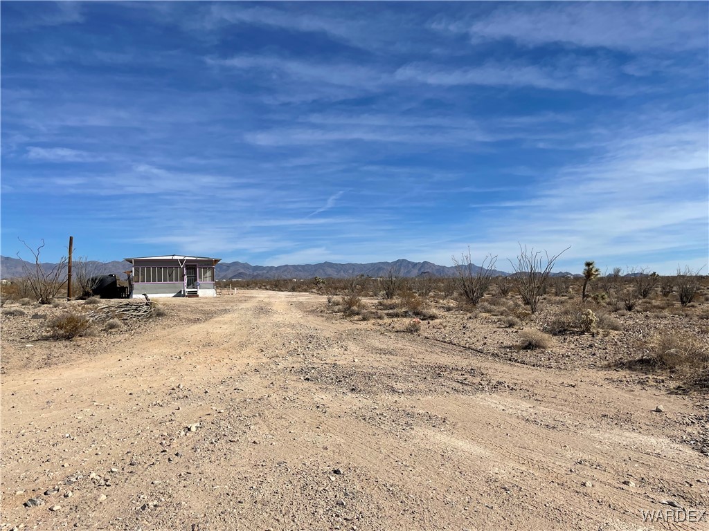 14360 Aripine Road Yucca, AZ 86438 - Photo 29 of 33 a view of a dry yard with wooden fence
