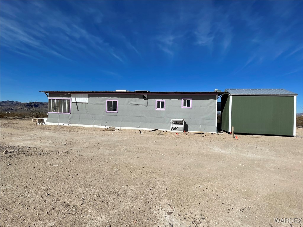 14360 Aripine Road Yucca, AZ 86438 - Photo 3 of 33 a front view of a house with a yard