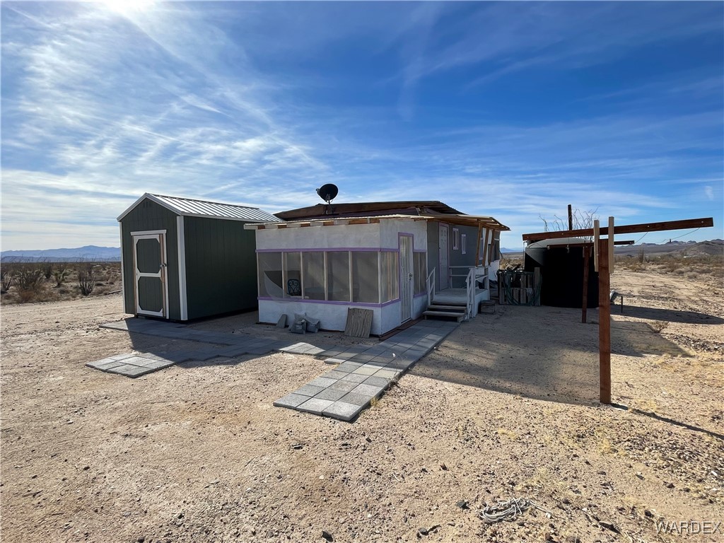 14360 Aripine Road Yucca, AZ 86438 - Photo 4 of 33 a view of a house with a yard
