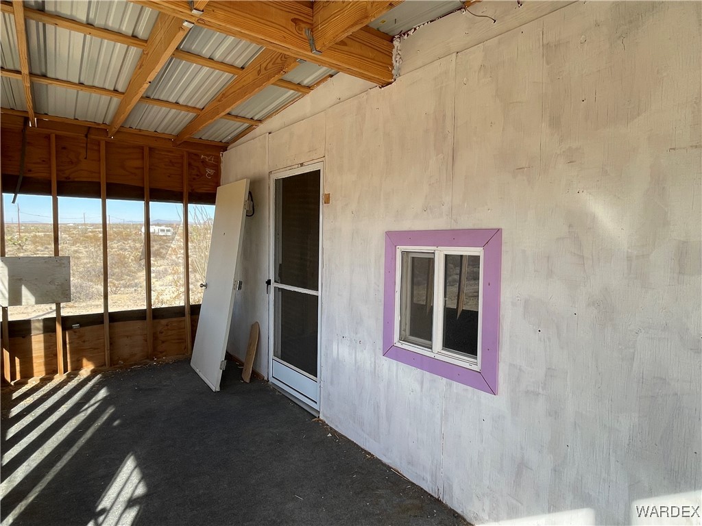 14360 Aripine Road Yucca, AZ 86438 - Photo 6 of 33 a view of empty room with wooden floor and fan