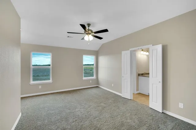 a view of room with hardwood floor and ceiling fan