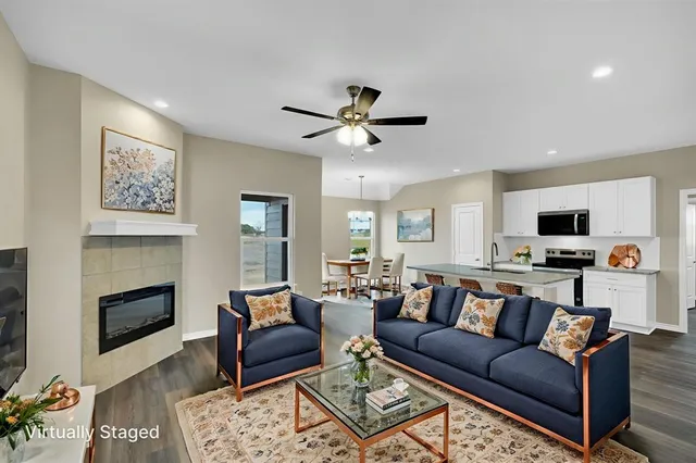 a view of living room with furniture and a fireplace