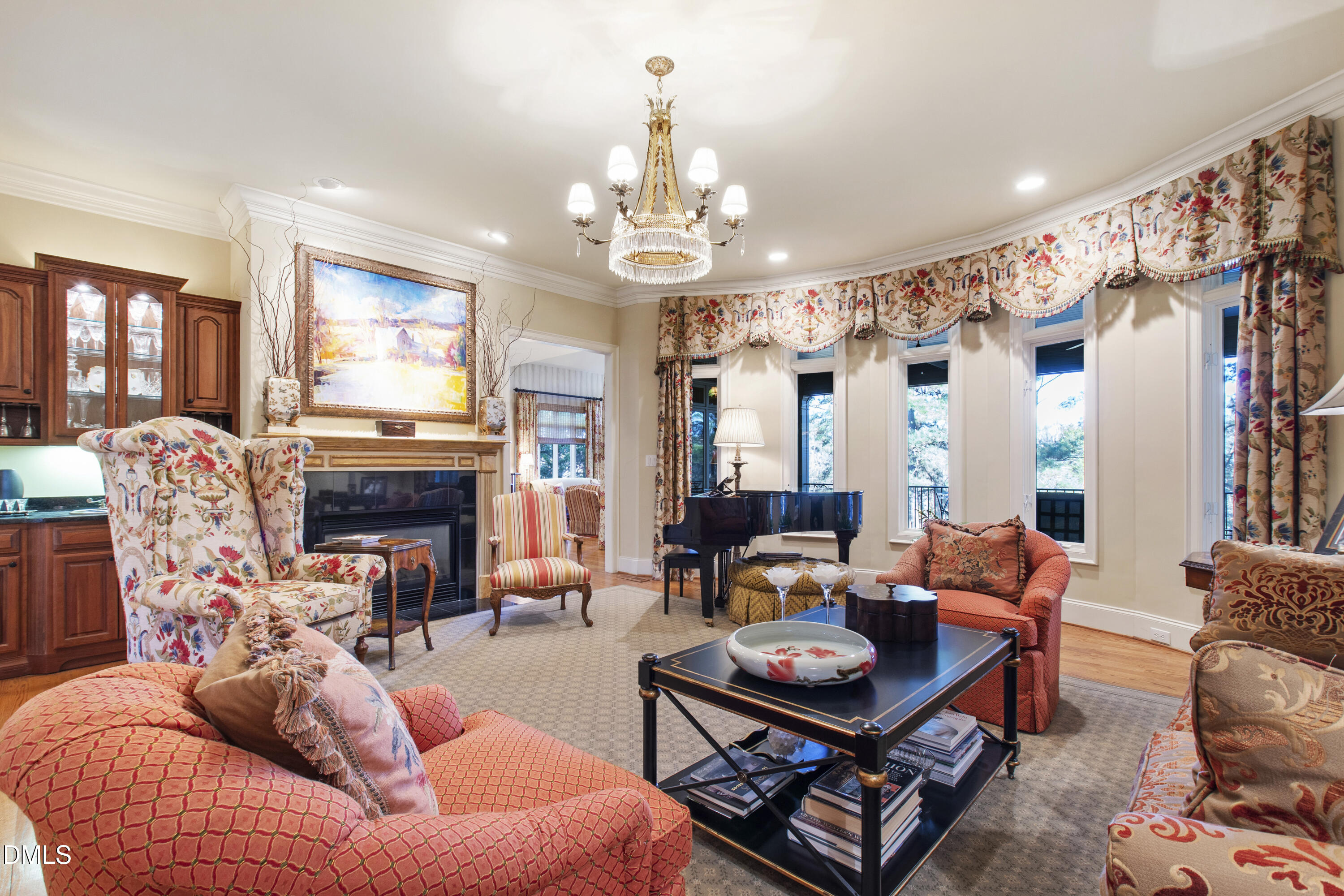 12345 Richmond Run Drive Raleigh, NC 27614 - Photo 21 of 90 a living room with furniture a fireplace and a chandelier