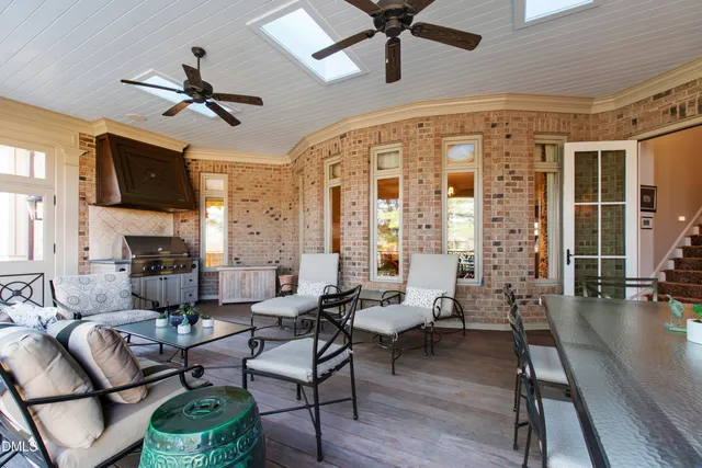a living room with furniture a fireplace and a chandelier